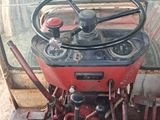 a red tractor that is sitting in a garage