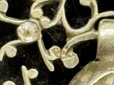 a close up of a silver object on a black surface