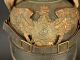 an old military helmet with a gold eagle on it