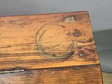 an old wooden box sitting on top of a wooden table