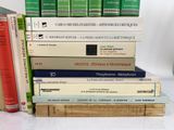 many books stacked on top of each other on a table