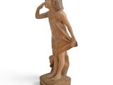 statue of a little girl standing on a block with her hand on her face