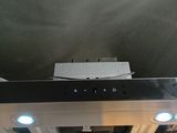 a black and white stove top with two blue lights on it