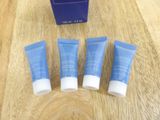 three tubes of skin care sitting on top of a wooden table