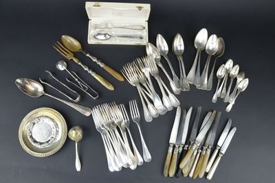 an assortment of silverware including spoons, forks and spoons
