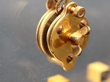 a close up of a clock with a chain attached to it