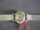 an image of a silver watch with a red string around it