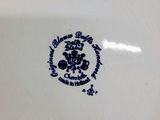 a white plate with a blue and black design on it