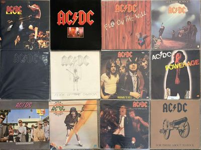 a lot of ac / dc album covers on the wall