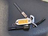 a keychain that has a key and a pen on it