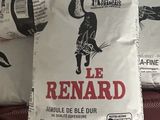 two bags of rice sitting on top of a bed next to each other
