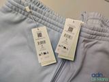two tags on a pair of pants hang on a hanger