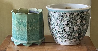 two vases that are sitting on a wooden table