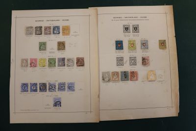 an open book with stamps on it sitting on top of a table