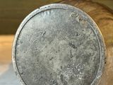 a metal container sitting on a marble counter top