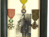 an old picture of a man in a military uniform in a picture frame