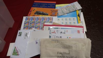 a bag of mail sitting on a table next to a bag of stamps