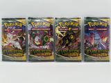 On voit trois paquets de cartes à collectionner Pokémon posés sur une surface blanche.