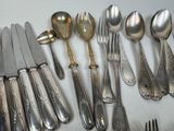 a lot of silver spoons and forks on the table