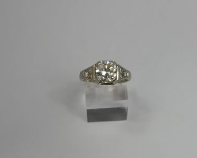 an old cut diamond ring on a clear acrylic stand