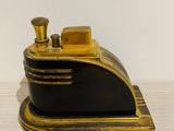 a black and gold model of a train on a table