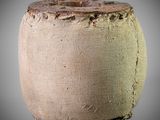 a close up of a vase on a gray surface