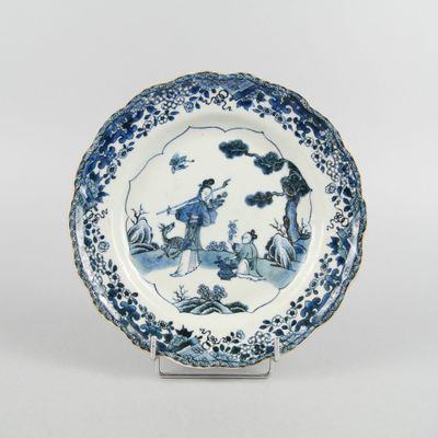 a blue and white plate with a picture of a man and a woman