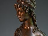 bronze statue of a woman holding a basket of fruit in her hands