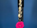 pink flower dangle earrings on a silver chain with a blue background
