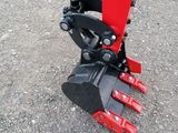 a close up of a red and black machine on the ground