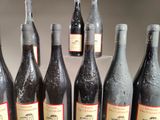 several bottles of wine are lined up on a table