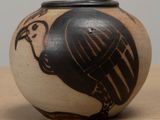 a black and white vase with a bird on it
