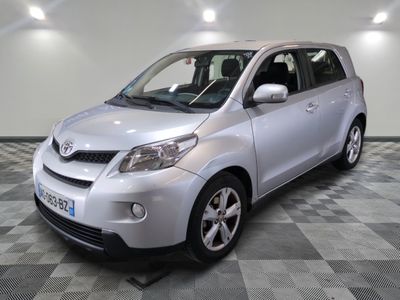 a picture of a small silver car parked in a garage