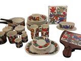 many different types of dishes and cups on this table