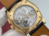 a close up of a wrist watch with a gold case