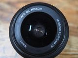 a camera lens that is sitting on a wooden table