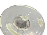 a clear glass candle holder on a white surface