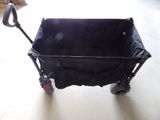 a black stroller with a black seat and handlebars