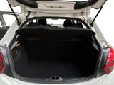 the back of a white car with its trunk open showing the rear seats