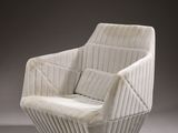a white chair with a quilted back and seat