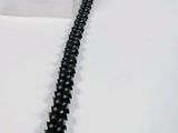 a black chain that is on a white table