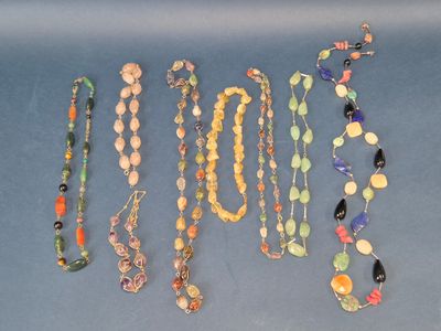 a lot of different necklaces that are on a table