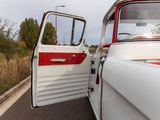 a red and white truck parked on the side of the road