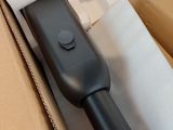 a black blow dryer sitting inside of a cardboard box