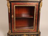 a black and red cabinet with gold decorations on it