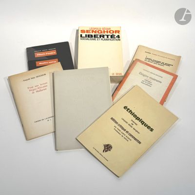 several books sitting on top of each other on top of a table