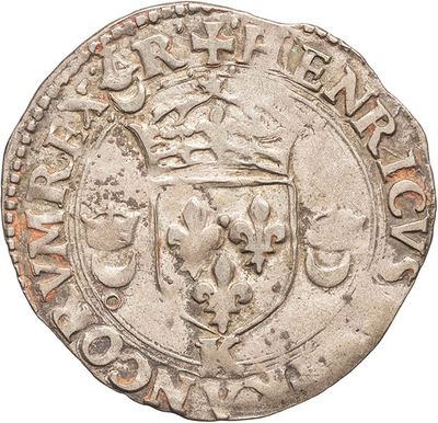 a silver coin with a coat of arms on it