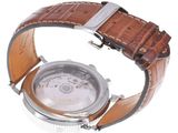 a close up of a watch on a white surface