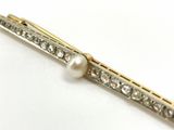 an image of a pearl and diamond hair clip on a white surface