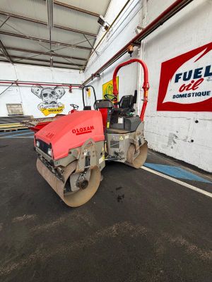 an image of a red roller in a parking lot